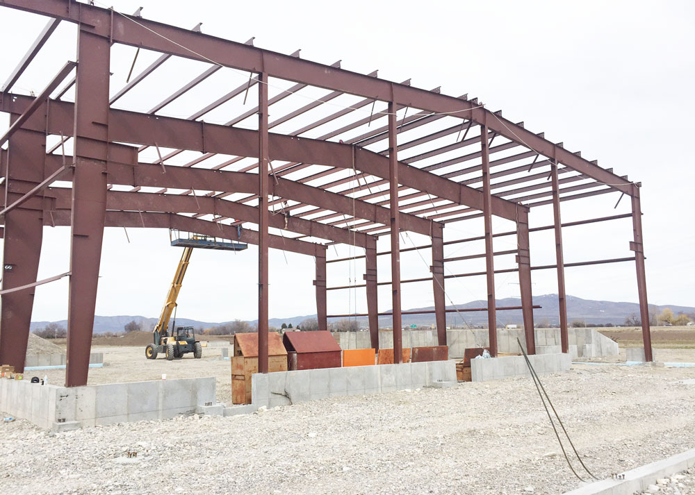 red steel framing with an yellow construction lift