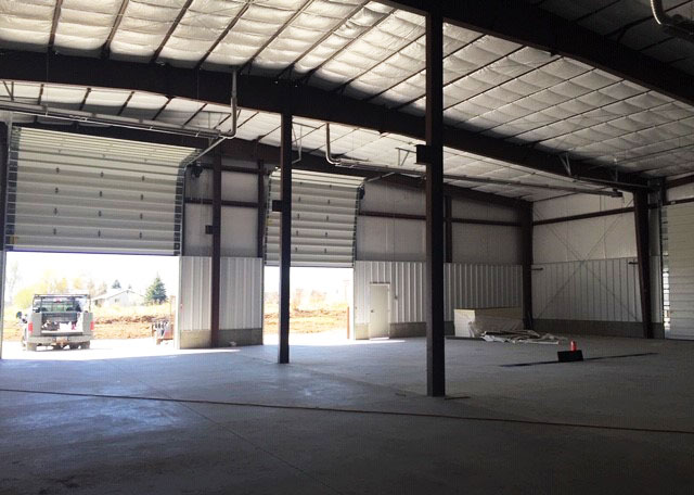 a large garage made of steel with two doors