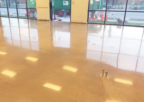 a polished concreted floor with glass windows