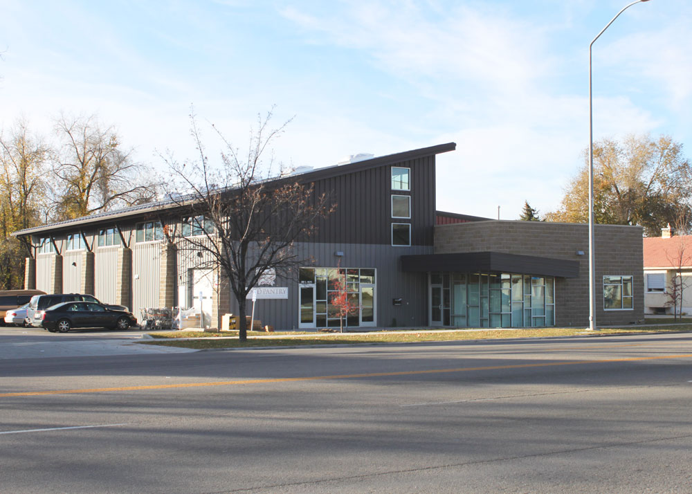 a black and grey retail store building made out of steel with wainscot