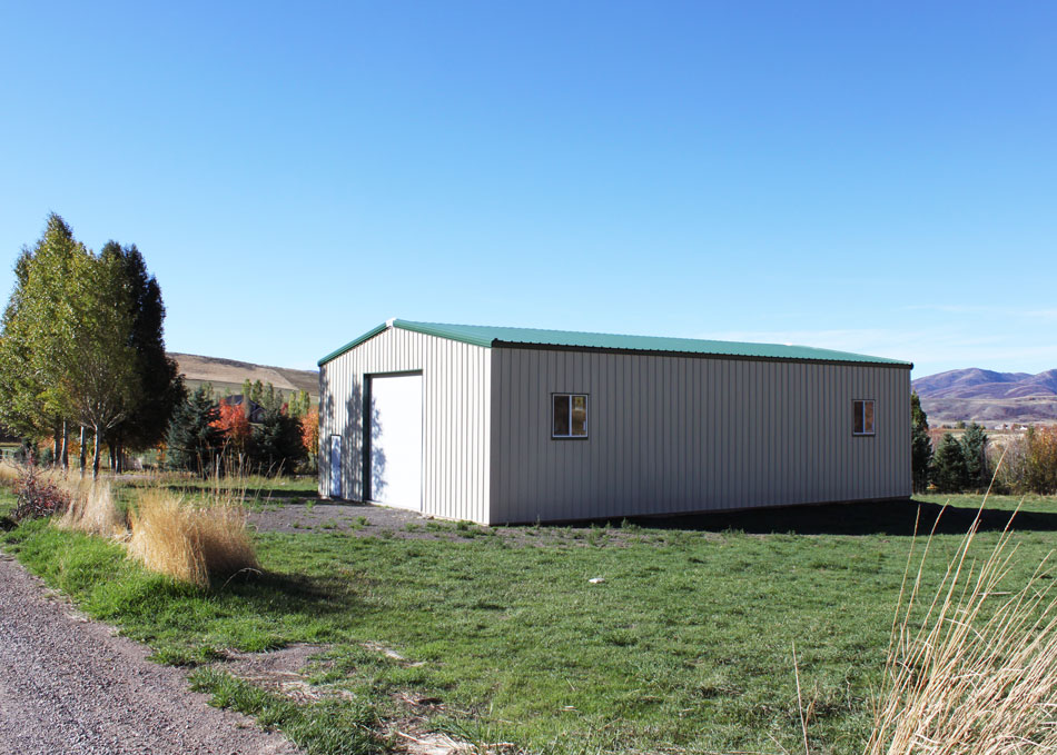 a small shed made of steel with green roof
