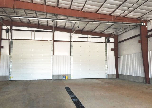 a large steel garage with two doors