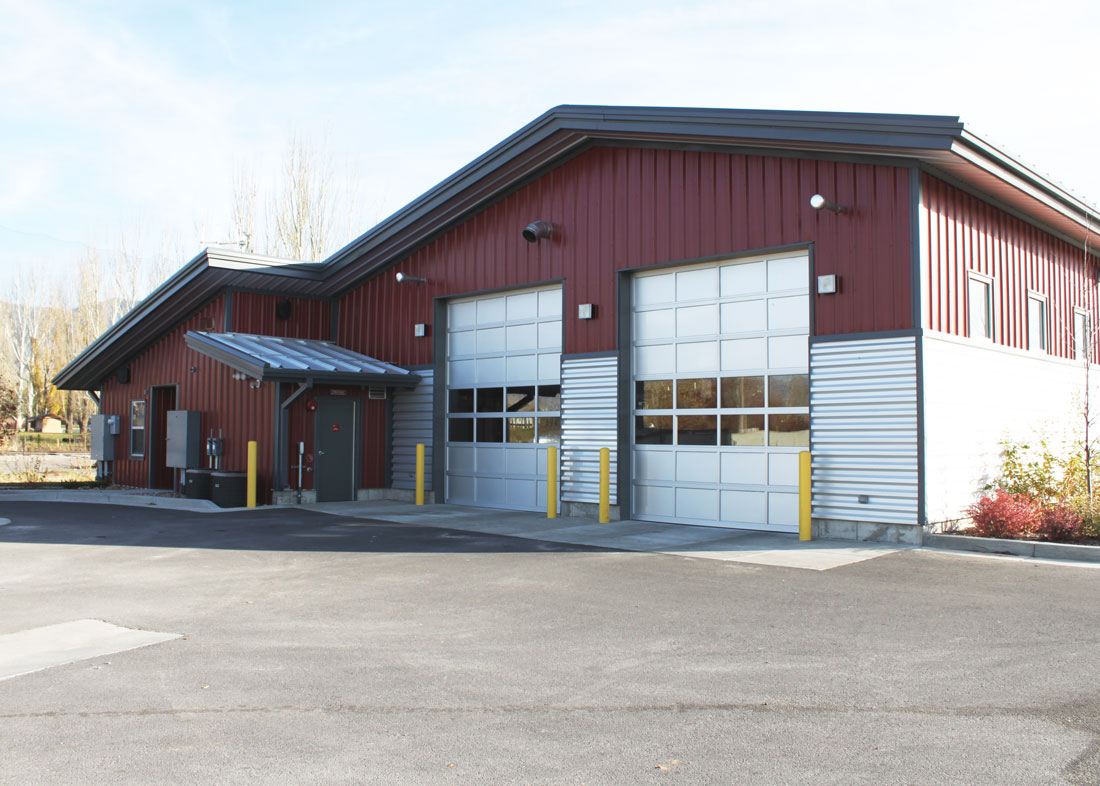 a fire station building made out of steel located in a rural setting